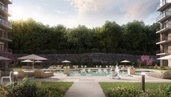 A person is walking in a garden with a swimming pool at The Woods at 180 Kanata Avenue, Kanata